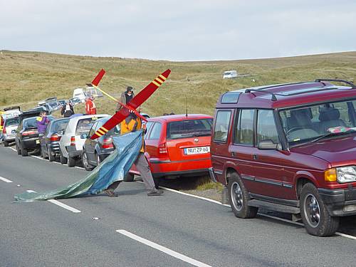 Just part of the line of cars which stretched from North to South Wales That's Ulrich Hauser crossing the road, with his Mirage and rain sheet.
