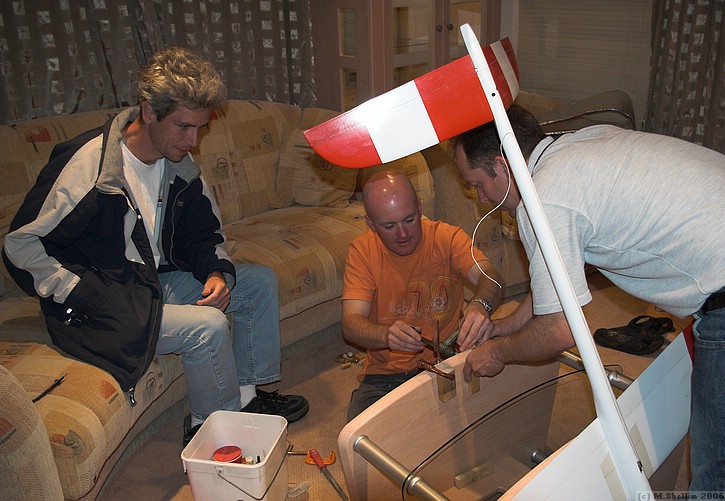 Shane Biddlecombe and Mike Young making a balancing rig out of caravan parts. Alex McMeekin looks on