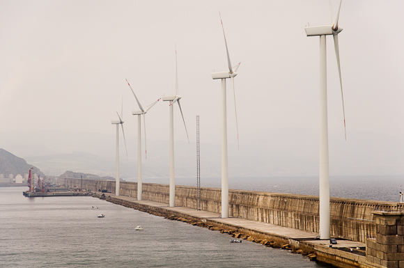 Wind turbines at entrance to Bilbao, taken from one of the upper decks of the ferry. The scale is deceptive - the turbines are actually quite huge - note the boats, and the car at the base of the nearest turbine.